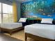 Two twin beds in a room with a jungle mural at 4560 Yellowgold E Rd # 108, Kissimmee, FL 34746