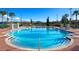 Community pool with brick deck and surrounding landscaping at 4560 Yellowgold E Rd # 108, Kissimmee, FL 34746