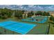 Community tennis and basketball courts with blue and green surfaces at 4560 Yellowgold E Rd # 108, Kissimmee, FL 34746