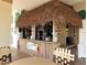 Community tiki bar with thatched roof and outdoor seating at 4560 Yellowgold E Rd # 108, Kissimmee, FL 34746