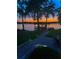 Brick pathway to lakefront boathouse at sunset at 491 Carolyn Dr, Oviedo, FL 32765