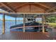 Covered boat lift in a lakeside boathouse at 491 Carolyn Dr, Oviedo, FL 32765