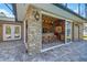 Outdoor kitchen with brick accents and sliding glass doors at 491 Carolyn Dr, Oviedo, FL 32765