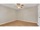 Spacious bedroom featuring wood flooring, a ceiling fan, and neutral colored walls at 505 Harvard Pl, Apopka, FL 32703