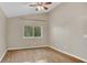 Light filled bedroom with wood flooring, neutral walls, ceiling fan, and large window at 505 Harvard Pl, Apopka, FL 32703