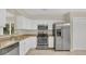 Well-lit kitchen with stainless steel appliances and white cabinets and countertops at 505 Harvard Pl, Apopka, FL 32703