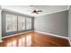 Bedroom with hardwood floors, gray walls, and windows at 5419 Baldwin Park St, Orlando, FL 32814