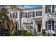 Front view of a charming townhome with dark shutters and landscaping at 5419 Baldwin Park St, Orlando, FL 32814