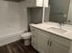 Modern bathroom with white vanity, quartz countertop, and bathtub at 5538 Pga Nw Blvd # 5025, Orlando, FL 32839