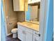 Bright bathroom featuring a white vanity, updated fixtures, and a mirrored medicine cabinet at 5538 Pga Nw Blvd # 5025, Orlando, FL 32839