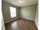 Spacious bedroom with large window and wood-look floors at 5538 Pga Nw Blvd # 5025, Orlando, FL 32839