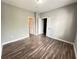 Bright bedroom with wood-look floors and access to bathroom and other bedroom at 5538 Pga Nw Blvd # 5025, Orlando, FL 32839