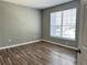 Well-lit bedroom featuring a large window and wood-look floors at 5538 Pga Nw Blvd # 5025, Orlando, FL 32839