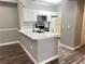 Modern kitchen with white cabinets, quartz countertops, and stainless steel appliances at 5538 Pga Nw Blvd # 5025, Orlando, FL 32839