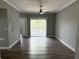 Spacious living room with wood-look floors and sliding glass doors to balcony at 5538 Pga Nw Blvd # 5025, Orlando, FL 32839