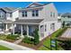 Two-story house with gray siding, a front porch, and landscaping at 5586 Stockade Blvd, St Cloud, FL 34771