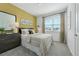 Bedroom with mustard yellow accent wall at 5586 Stockade Blvd, St Cloud, FL 34771