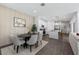 Bright dining area featuring a modern table set, stylish decor, and an open layout flowing into the kitchen at 5586 Stockade Blvd, St Cloud, FL 34771