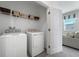 Bright laundry room with washer, dryer, and shelving at 5586 Stockade Blvd, St Cloud, FL 34771