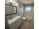 Clean bathroom with white vanity and bathtub shower combo at 610 Thomas Ave, Winter Haven, FL 33880