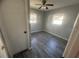 Bright bedroom with wood-look floors and ceiling fan at 610 Thomas Ave, Winter Haven, FL 33880