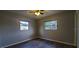 Well lit bedroom with new wood-look flooring and two windows at 610 Thomas Ave, Winter Haven, FL 33880