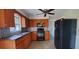 Bright kitchen with wood cabinets, granite countertops, and modern appliances at 610 Thomas Ave, Winter Haven, FL 33880