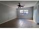 Spacious living room featuring tile floors and a ceiling fan at 610 Thomas Ave, Winter Haven, FL 33880