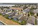 Aerial view of neighborhood with houses, pools, and a lake in the distance at 627 Copeland Dr, Haines City, FL 33844