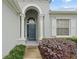 Elegant entryway with a dark blue door and columns at 627 Copeland Dr, Haines City, FL 33844