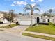 One-story house with a two-car garage and manicured lawn at 627 Copeland Dr, Haines City, FL 33844