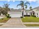 One story house with a two-car garage and lush landscaping at 627 Copeland Dr, Haines City, FL 33844