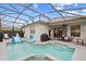 Large screened pool and spa with patio furniture and grill at 627 Copeland Dr, Haines City, FL 33844