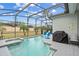 Inviting pool and spa with grill and patio furniture at 627 Copeland Dr, Haines City, FL 33844