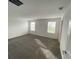 Bright bedroom with carpet flooring and two windows at 768 Staffora St, Haines City, FL 33844