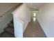 Bright entryway with tile floors and staircase leading upstairs at 768 Staffora St, Haines City, FL 33844