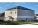 Rear view of house showing solar panels on the roof and a fenced backyard at 768 Staffora St, Haines City, FL 33844