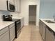 Modern kitchen with gray cabinets, stainless steel appliances, and an island at 768 Staffora St, Haines City, FL 33844