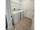 Cozy laundry room with washer, dryer, tile flooring and wire shelving at 768 Staffora St, Haines City, FL 33844