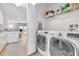 Bright laundry room with washer, dryer, and ample shelving at 7729 Country Pl, Winter Park, FL 32792