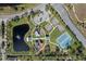 Aerial view showing community amenities such as tennis courts, playground, and pond at 820 Spring Oak Cir, Orlando, FL 32828