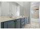 Bathroom boasts a double vanity with blue cabinets and a separate tub at 820 Spring Oak Cir, Orlando, FL 32828