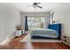 Bedroom with a blue bed, hardwood floors, and large windows at 820 Spring Oak Cir, Orlando, FL 32828