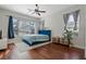 Bright bedroom featuring hardwood floors and a blue bed at 820 Spring Oak Cir, Orlando, FL 32828