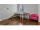 Bedroom featuring a built-in bunk bed, hardwood floors, and a pink chair at 820 Spring Oak Cir, Orlando, FL 32828