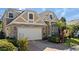 Stunning two-story house, stone and beige accents, three-car garage, manicured landscaping at 820 Spring Oak Cir, Orlando, FL 32828