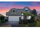 Two-story house with stone accents and a three-car garage,solar panels,landscaped yard at 820 Spring Oak Cir, Orlando, FL 32828