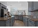 Gray kitchen with granite countertops, stainless steel appliances, and an island at 820 Spring Oak Cir, Orlando, FL 32828