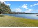 Serene lake view with lush green grass at 820 Spring Oak Cir, Orlando, FL 32828