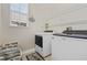 Laundry room with washer, dryer, and shelving at 820 Spring Oak Cir, Orlando, FL 32828